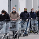 People standing in line with grocery carts